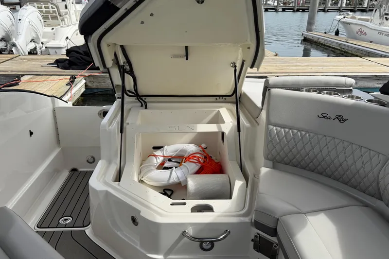 Slide: The Image of 2023 Sea Ray SLX 260 Outboard with open storage at the dock. - 25