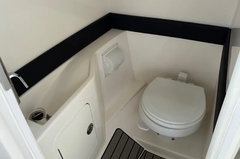 Slide: The Image of Interior of 2023 Sea Ray SLX 260 Outboard with toilet. - 26