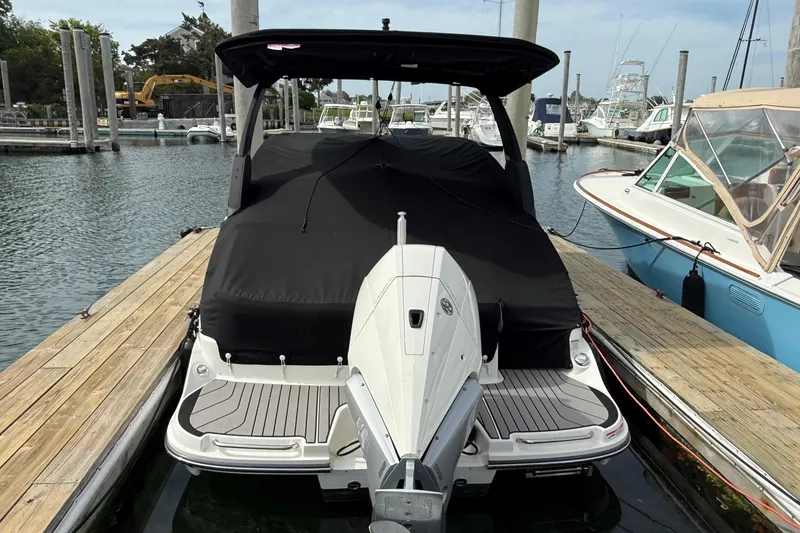 Slide: The Image of 2023 Sea Ray SLX 260 Outboard at dock, covered. - 33