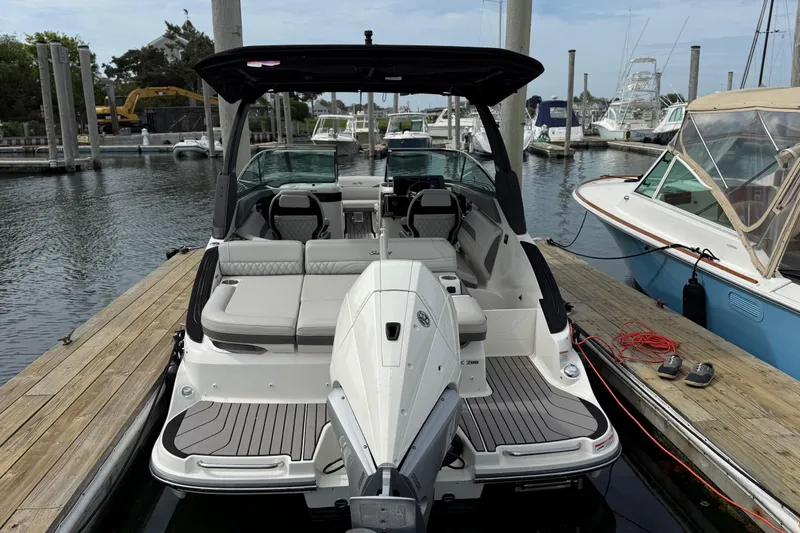 Slide: The Image of 2023 Sea Ray SLX 260 Outboard docked, showcasing luxury design. - 4