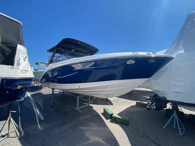 Slide: The Image of 2023 Sea Ray SLX 260 Outboard boat in a parking area. - 5