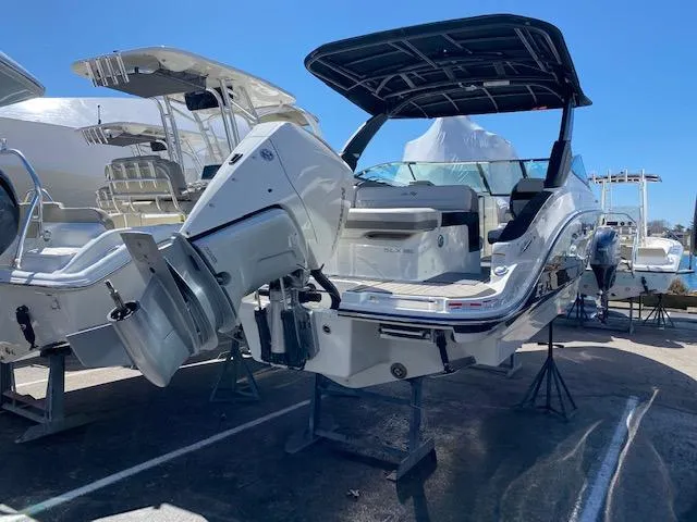 Slide: The Image of 2023 Sea Ray SLX 260 Outboard boat on display. - 6