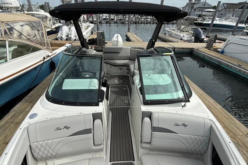 Slide: The Image of 2023 Sea Ray SLX 260 Outboard at dock, luxurious design. - 9