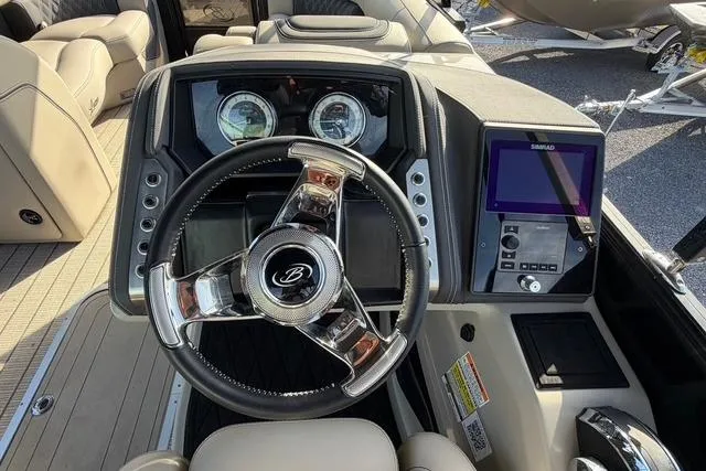 Slide: The Image of 2023 Barletta L23U boat dashboard with steering wheel and navigation display. - 12
