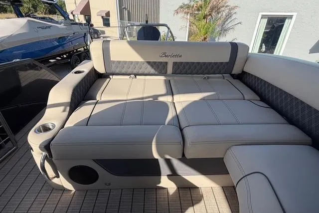 Slide: The Image of 2023 Barletta L23U boat interior with luxurious seating and cup holders. - 15