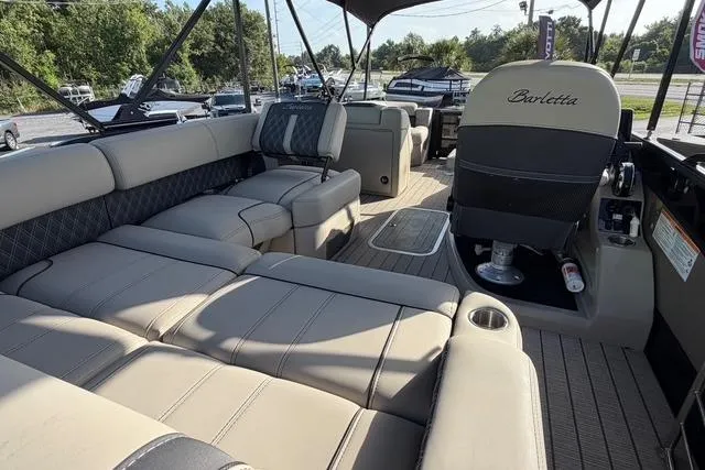 Slide: The Image of 2023 Barletta L23U pontoon boat interior with luxurious seating and helm. - 16