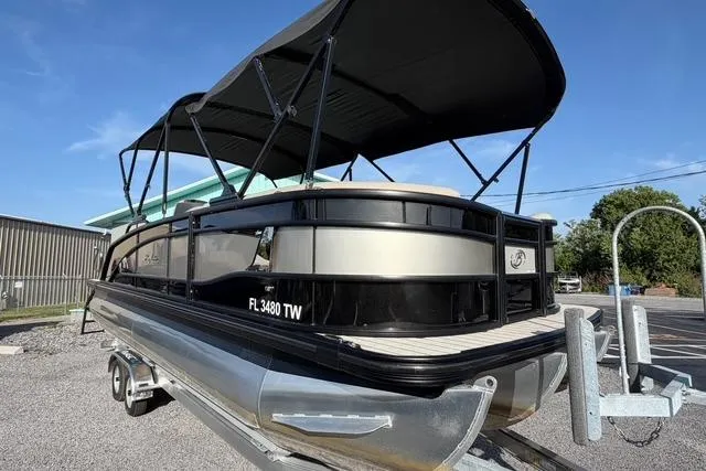 Slide: The Image of 2023 Barletta L23U pontoon boat on trailer, featuring a sleek black and silver design. - 4