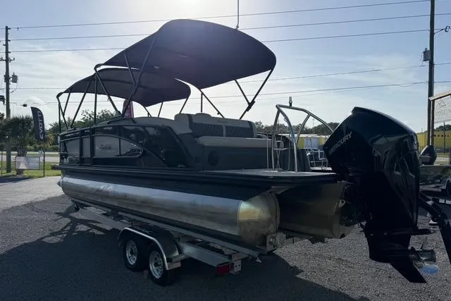 Slide: The Image of 2023 Barletta L23U pontoon boat on trailer with canopy and Mercury outboard motor. - 7