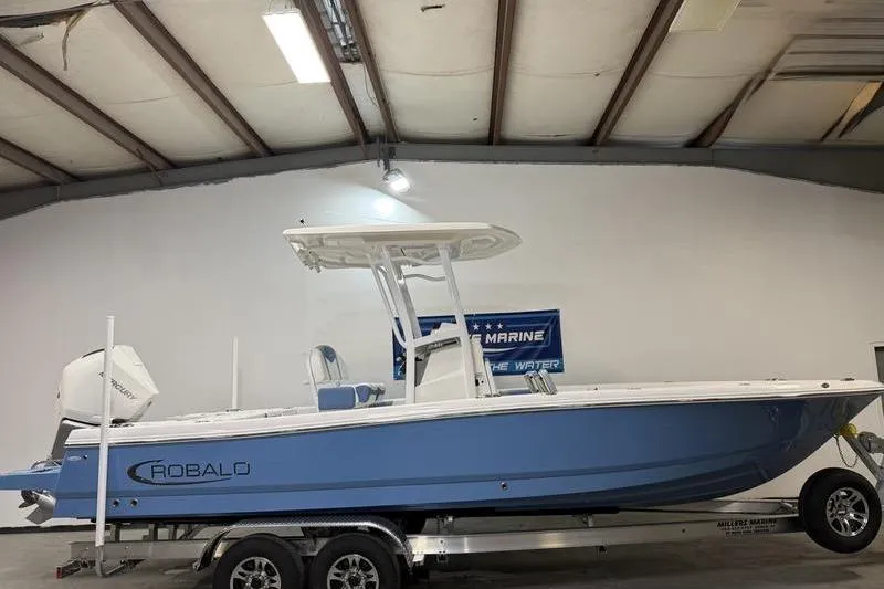 The Image of 2026 Robalo 246 Cayman boat in a warehouse on a trailer. - 0