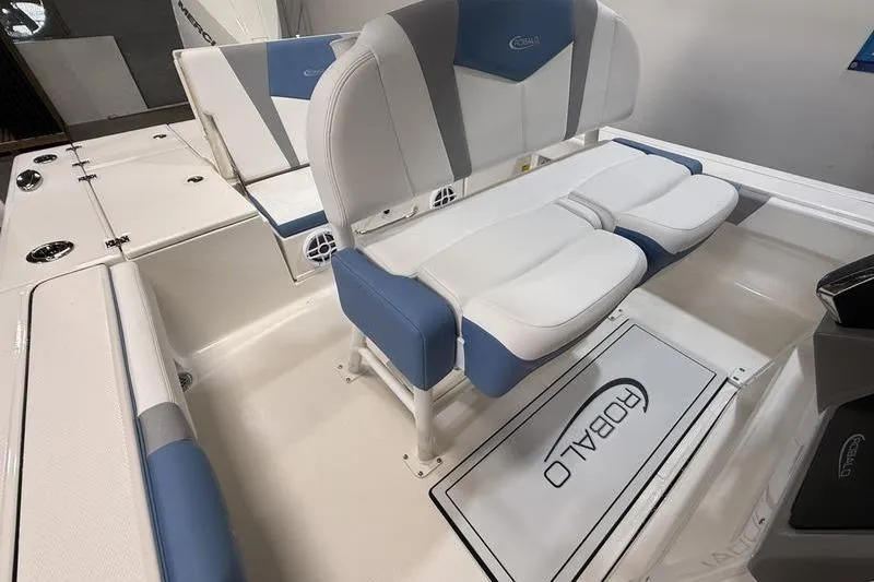 Slide: The Image of Interior of 2026 Robalo 246 Cayman with blue and white seating. - 10