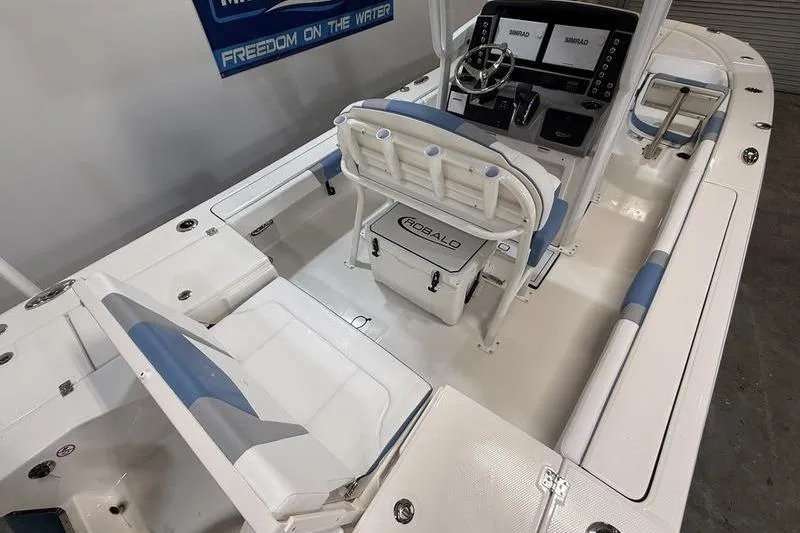 Slide: The Image of 2026 Robalo 246 Cayman boat interior with seating, steering console, and storage. - 11