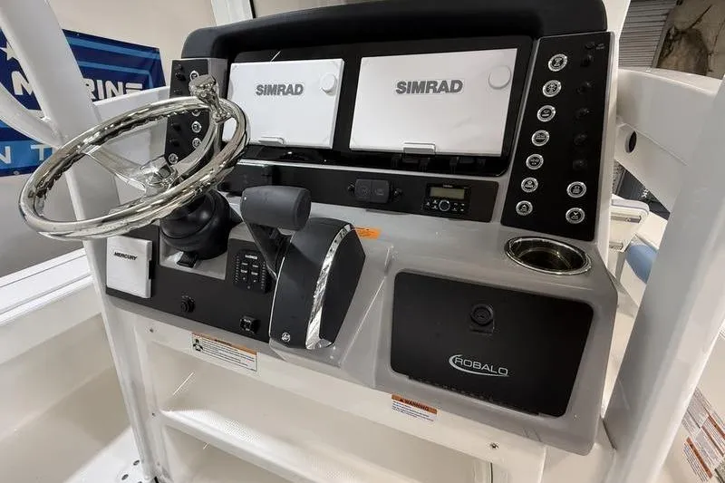 Slide: The Image of 2026 Robalo 246 Cayman dashboard with Simrad displays. - 17