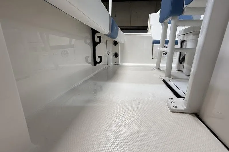 Slide: The Image of Interior of 2026 Robalo 246 Cayman with blue seating. - 19