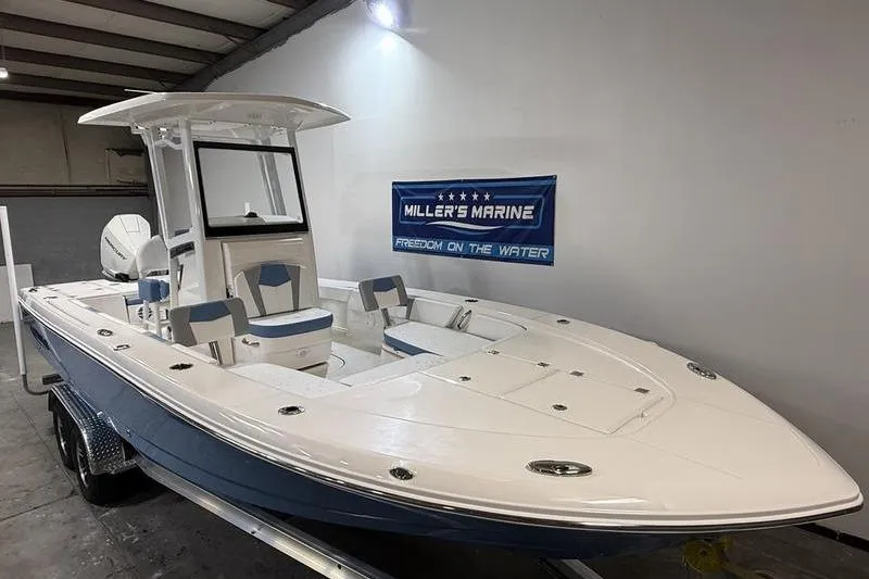 Slide: The Image of 2026 Robalo 246 Cayman boat in showroom at Miller's Marine. - 2