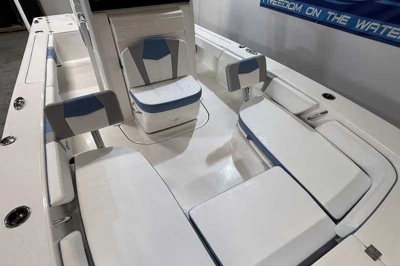 Slide: The Image of 2026 Robalo 246 Cayman boat interior with white and blue seating arrangement. - 23