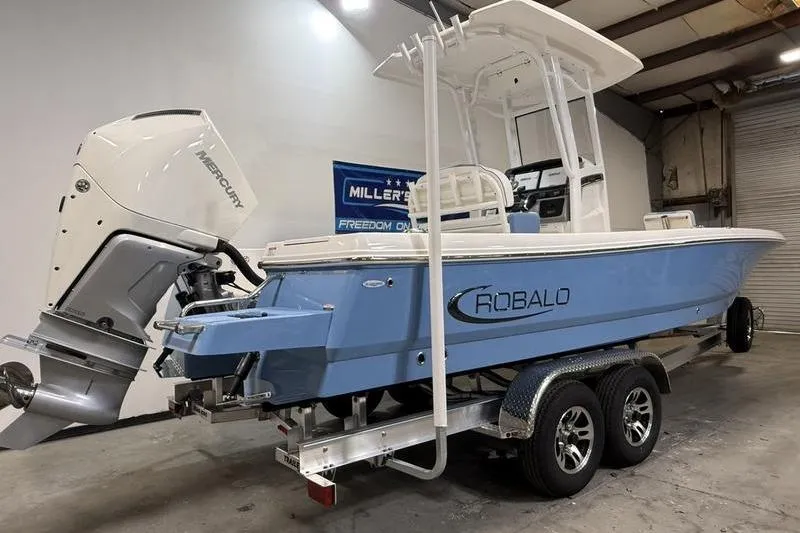 Slide: The Image of 2026 Robalo 246 Cayman boat in a warehouse setting. - 3