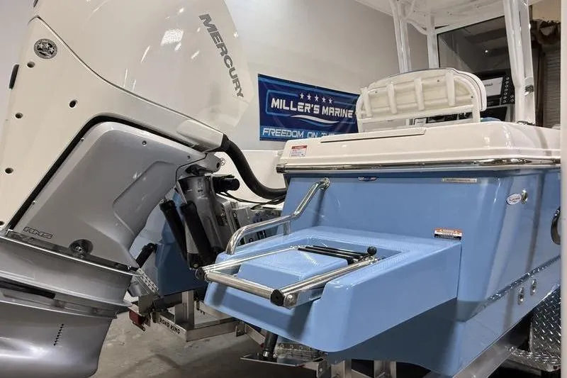 Slide: The Image of 2026 Robalo 246 Cayman boat with Mercury engine at Miller's Marine showroom. - 4