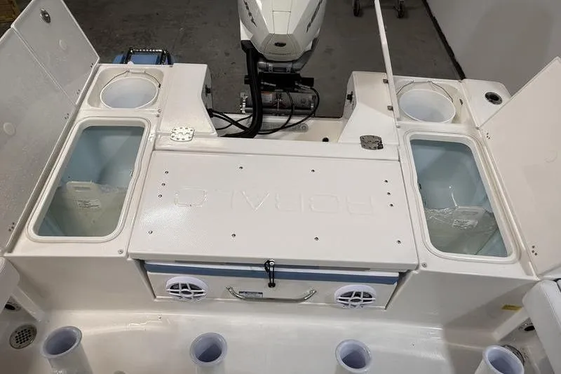 Slide: The Image of 2026 Robalo 246 Cayman boat deck with storage compartments and motor. - 7
