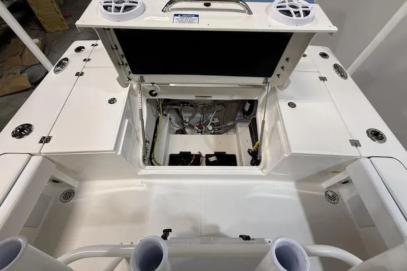 Slide: The Image of 2026 Robalo 246 Cayman boat interior showing open storage compartment and wiring. - 8