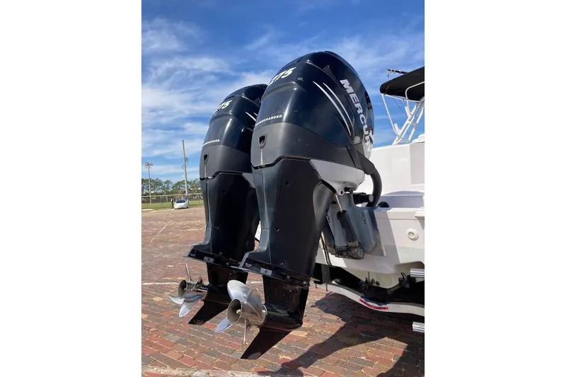 Slide: The Image of Twin Mercury outboard engines on a 2005 Donzi 35 ZF Daytona boat, parked on brick pavement. - 10