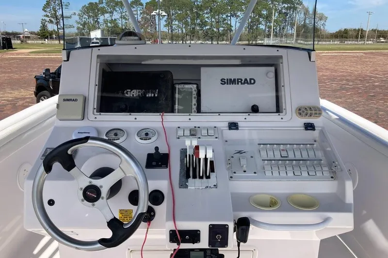Slide: The Image of 2005 Donzi 35 ZF Daytona boat dashboard with steering wheel and navigation controls. - 14