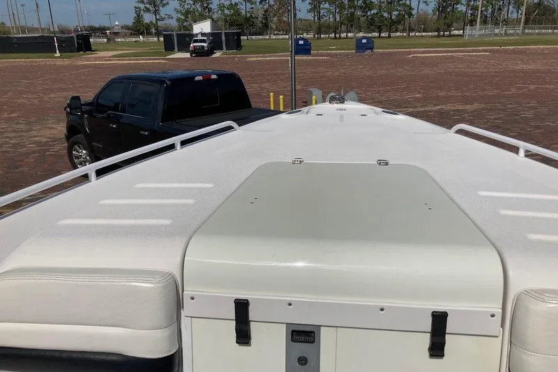 Slide: The Image of 2005 Donzi 35 ZF Daytona boat on trailer, parked near a black truck. - 16