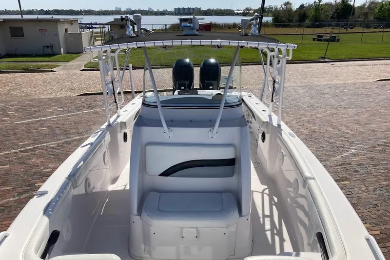 Slide: The Image of 2005 Donzi 35 ZF Daytona boat with dual engines, docked near a waterfront. - 17