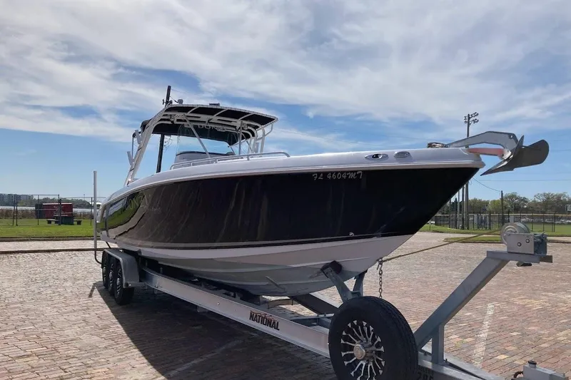 Slide: The Image of 2005 Donzi 35 ZF Daytona boat on trailer under a clear sky. - 2