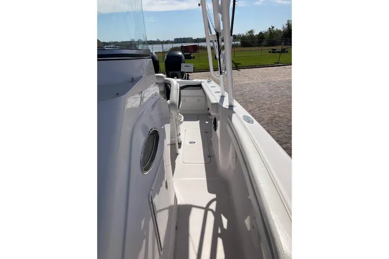 Slide: The Image of 2005 Donzi 35 ZF Daytona boat deck with sleek white design and outdoor view. - 23