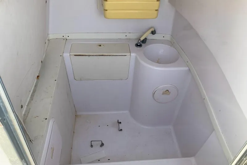 Slide: The Image of Interior of a 2005 Donzi 35 ZF Daytona boat bathroom with sink and storage. - 29