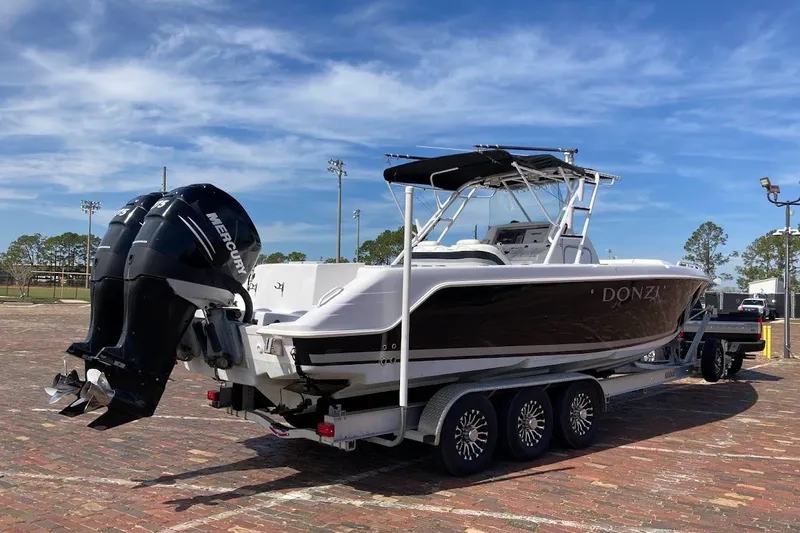 Slide: The Image of 2005 Donzi 35 ZF Daytona boat on trailer with twin Mercury outboard engines. - 4