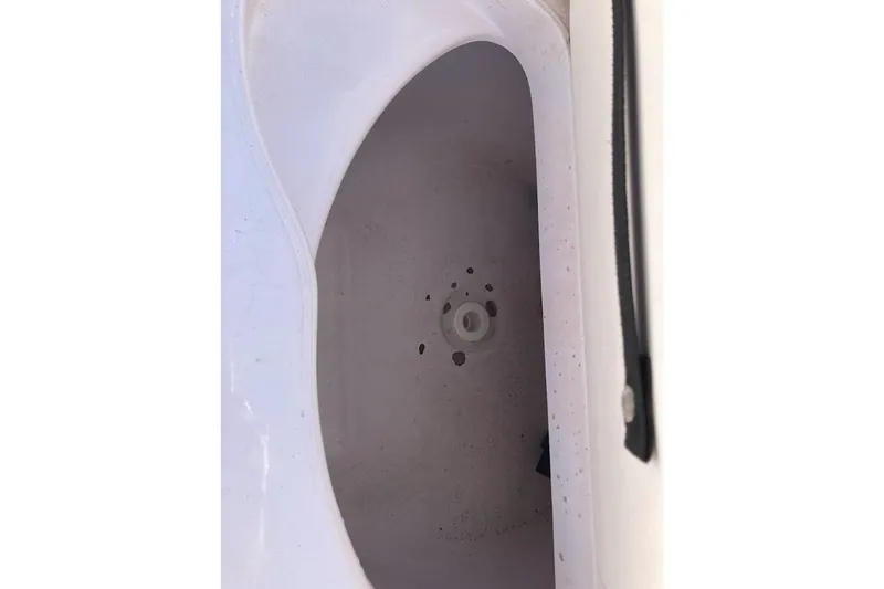 Slide: The Image of Storage compartment of a 2005 Donzi 35 ZF Daytona boat, featuring a white interior. - 43