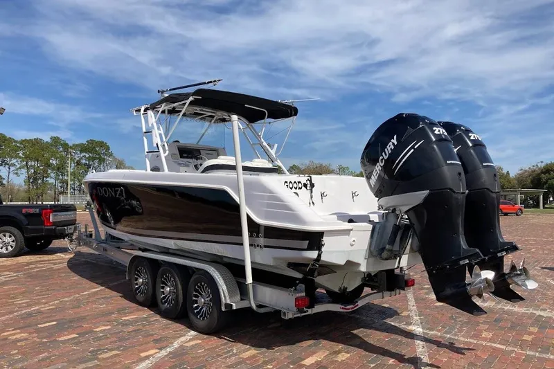 Slide: The Image of 2005 Donzi 35 ZF Daytona boat on trailer with twin Mercury engines. - 6
