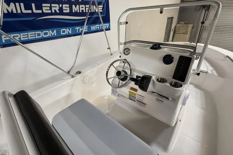 Slide: The Image of 2026 Robalo R160 Center Console with helm and instruments. - 11