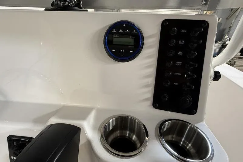 Slide: The Image of Dashboard of 2026 Robalo R160 Center Console with controls and cup holders. - 13