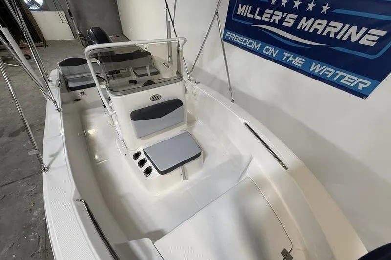 Slide: The Image of 2026 Robalo R160 Center Console boat in showroom. - 16