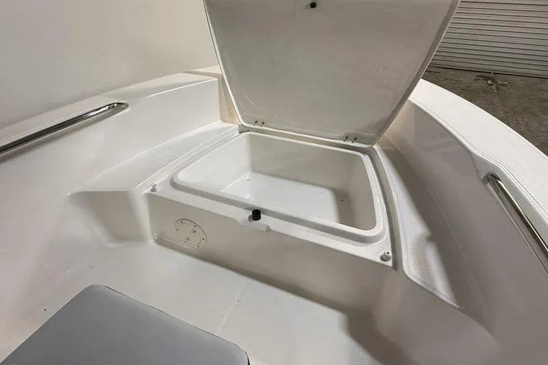 Slide: The Image of 2026 Robalo R160 Center Console with open storage compartment. - 21
