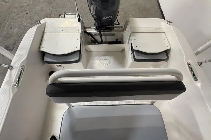 Slide: The Image of Robalo R160 Center Console 2026, interior view with motor and seating. - 6
