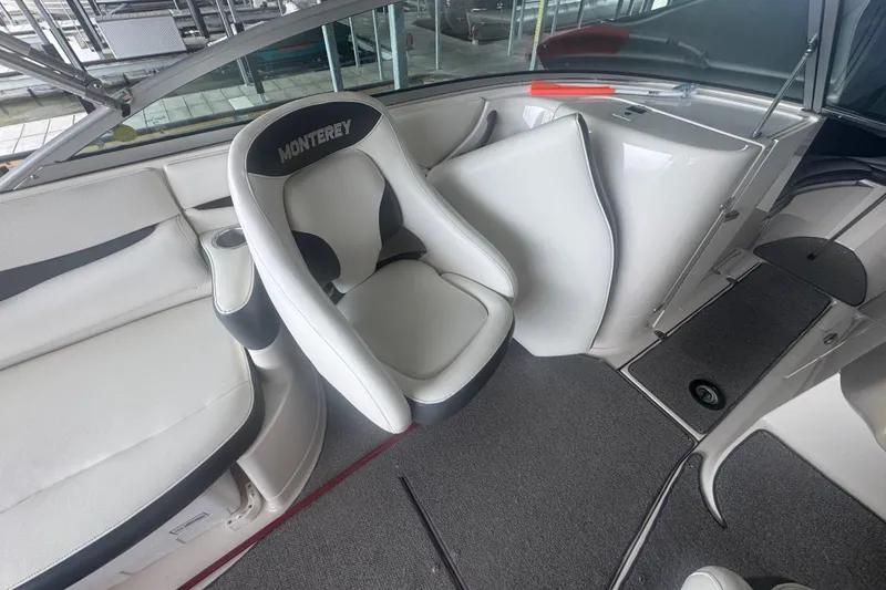 Slide: The Image of 2005 Monterey 248LS Montura Bowrider interior with white seating and carpeted flooring. - 10
