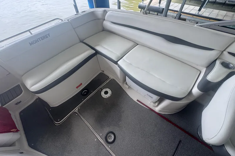 Slide: The Image of 2005 Monterey 248LS Montura Bowrider interior with white seating and cup holders. - 11