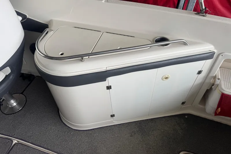 Slide: The Image of 2005 Monterey 248LS Montura Bowrider interior with storage compartment and seating area. - 13