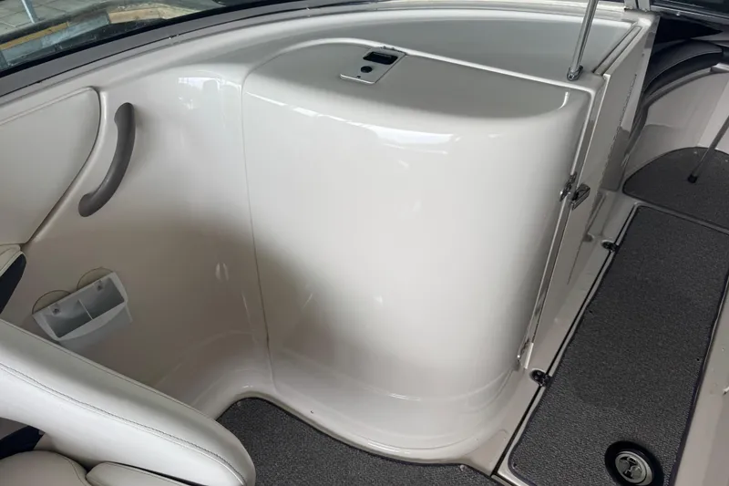 Slide: The Image of Interior view of a 2005 Monterey 248LS Montura Bowrider boat, featuring sleek white design. - 14