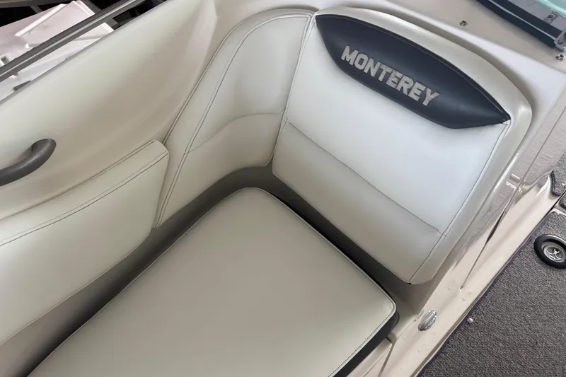 Slide: The Image of 2005 Monterey 248LS Montura Bowrider interior seating with logo detail. - 20