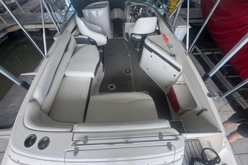 Slide: The Image of 2005 Monterey 248LS Montura Bowrider interior with seating and helm, docked at marina. - 27