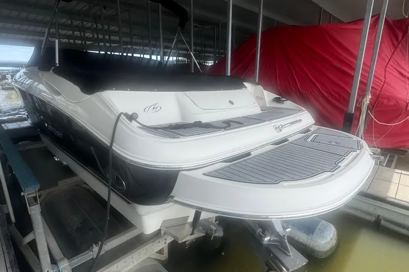 Slide: The Image of 2005 Monterey 248LS Montura Bowrider in dock, rear view, covered storage. - 3