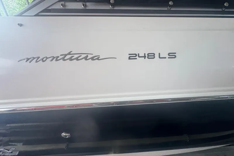 Slide: The Image of 2005 Monterey 248LS Montura Bowrider boat side view with model name displayed. - 6