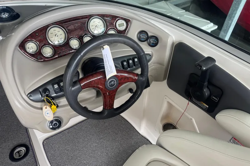 Slide: The Image of 2005 Monterey 248LS Montura Bowrider dashboard with steering wheel and gauges. - 8