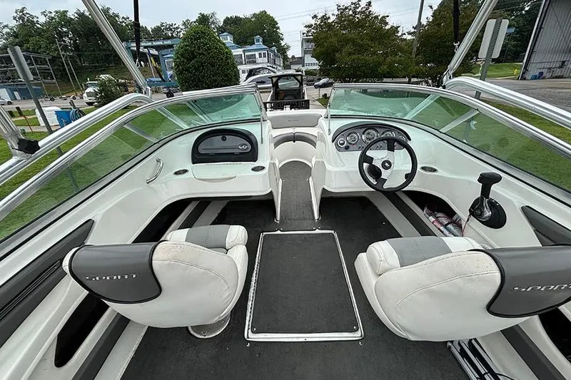 Slide: The Image of Interior view of a 2011 Sea Ray 205 Sport boat, featuring dual seating and steering console. - 10
