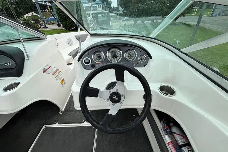 Slide: The Image of Steering console of a 2011 Sea Ray 205 Sport boat with gauges and controls. - 13