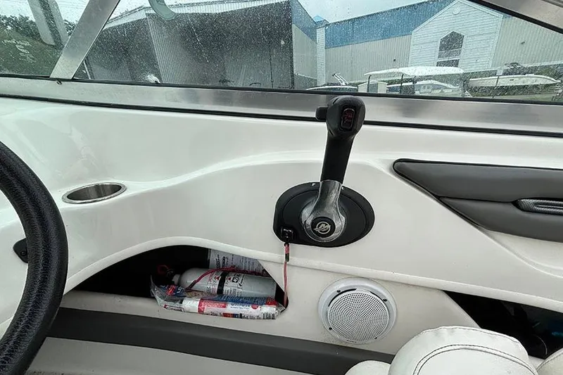 Slide: The Image of Interior view of a 2011 Sea Ray 205 Sport boat cockpit with throttle control. - 14